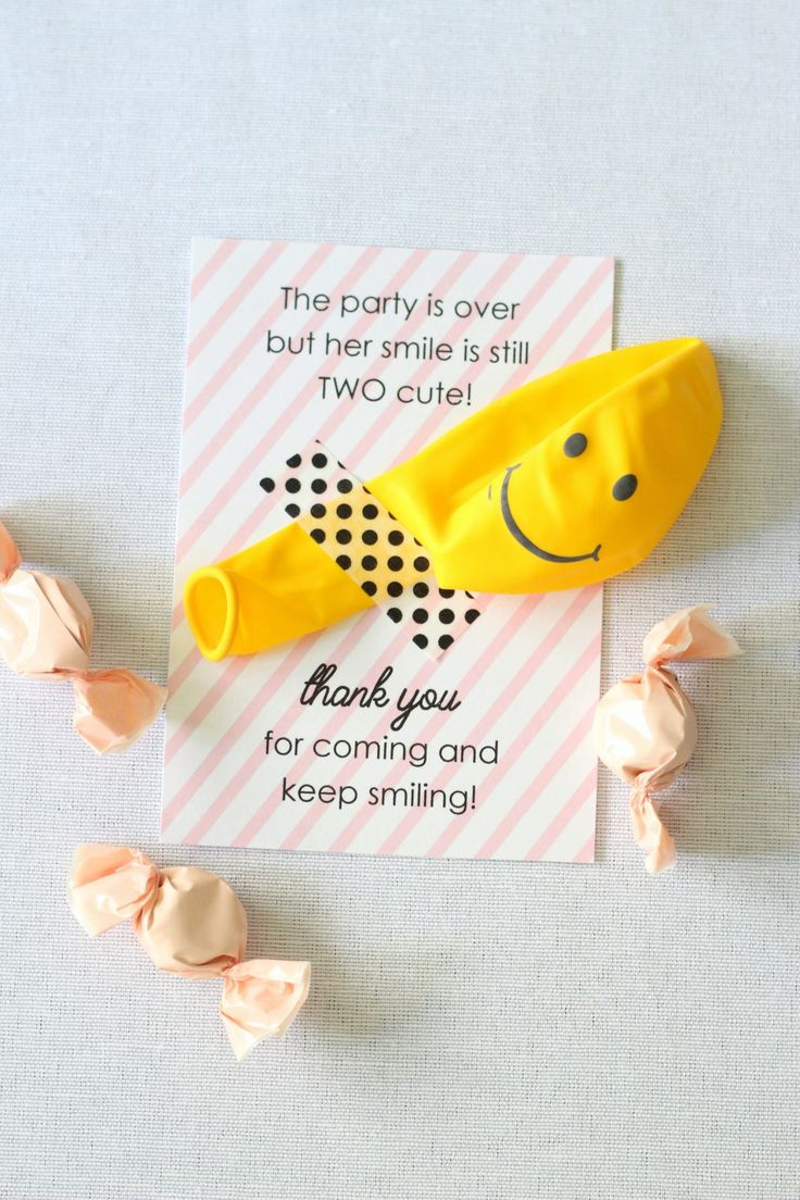 a yellow banana shaped candy on top of a card