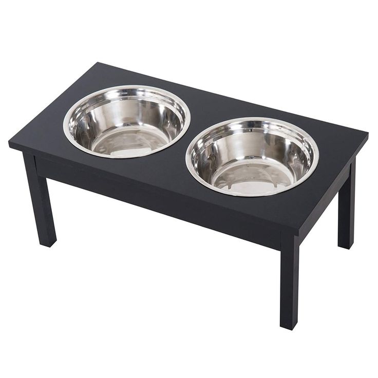 two stainless steel bowls sit on a black coffee table