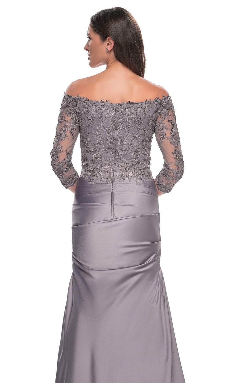 Make a striking impression at the event in the stunning La Femme 30853 creation. Exquisitely tailored with precision to enhance the feminine silhouette, this dress showcases an off-the-shoulder neckline atop a pleat-ornate satin silhouette. Sheer quarter sleeves adorned with lace details add a touch of elegance, while the full back design features a zipper closure for a seamless fit. The trumpet skirt is meticulously sculpted to flatter and flares gracefully into a sweep train, adding a hint of Elegant Off Shoulder Dress For Gala, Gala Off-shoulder Evening Dress With Fitted Bodice, Off-shoulder Evening Dress With Fitted Bodice For Gala, Off-shoulder Mother Of The Bride Dress For Gala, Elegant Off Shoulder Boat Neck Dress For Formal Occasions, Elegant Off-shoulder Evening Dress For Gala, Off-shoulder Fitted Evening Dress For Formal Occasions, Elegant Off-shoulder Evening Dress With Fitted Bodice, Off-shoulder Fitted Formal Evening Dress