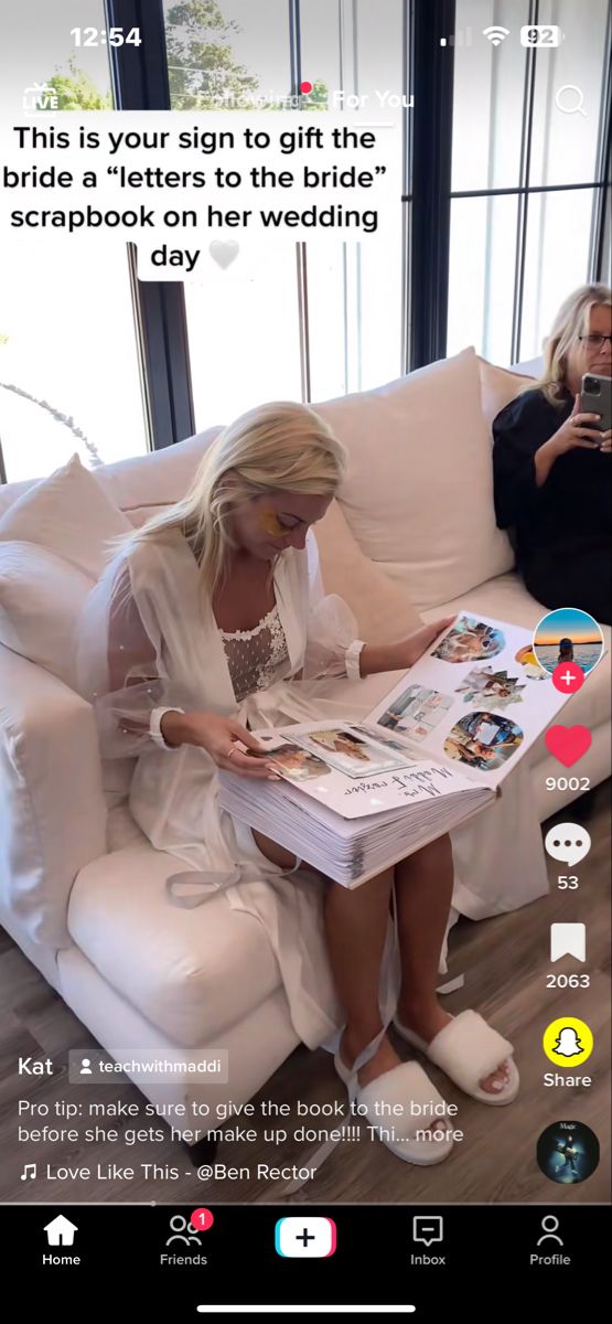 a woman sitting on a couch reading a magazine