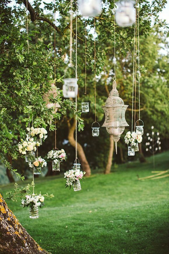 an outdoor wedding with hanging lanterns and flowers