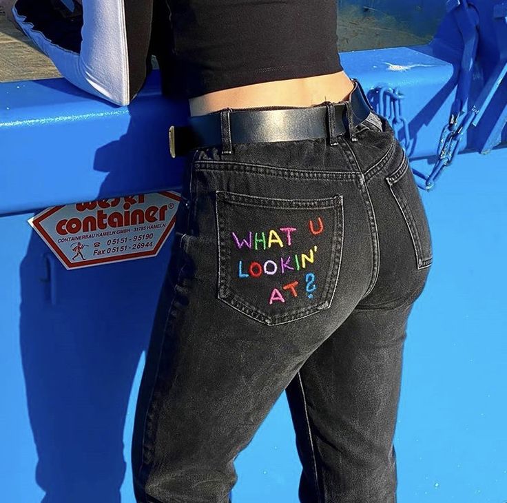 the back of a woman's jeans with what u lookin at? written on it