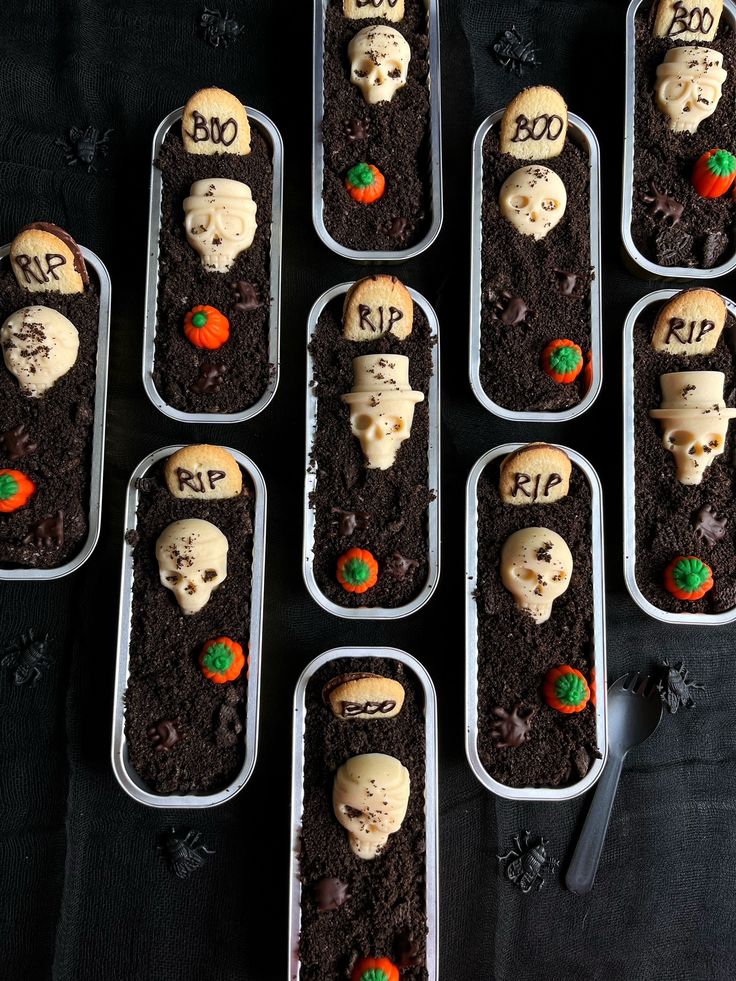 six trays filled with halloween treats on top of a table