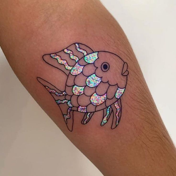 a colorful fish tattoo on the left leg and right leg with holographics