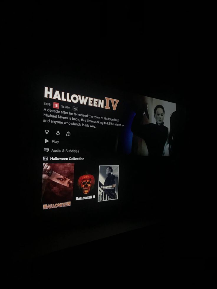 the screen on the wall is lit up with halloween iv