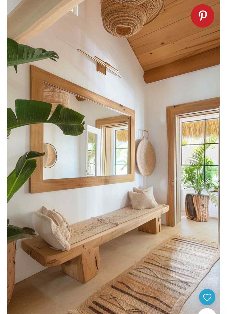 a wooden bench sitting under a mirror in a living room next to a potted plant