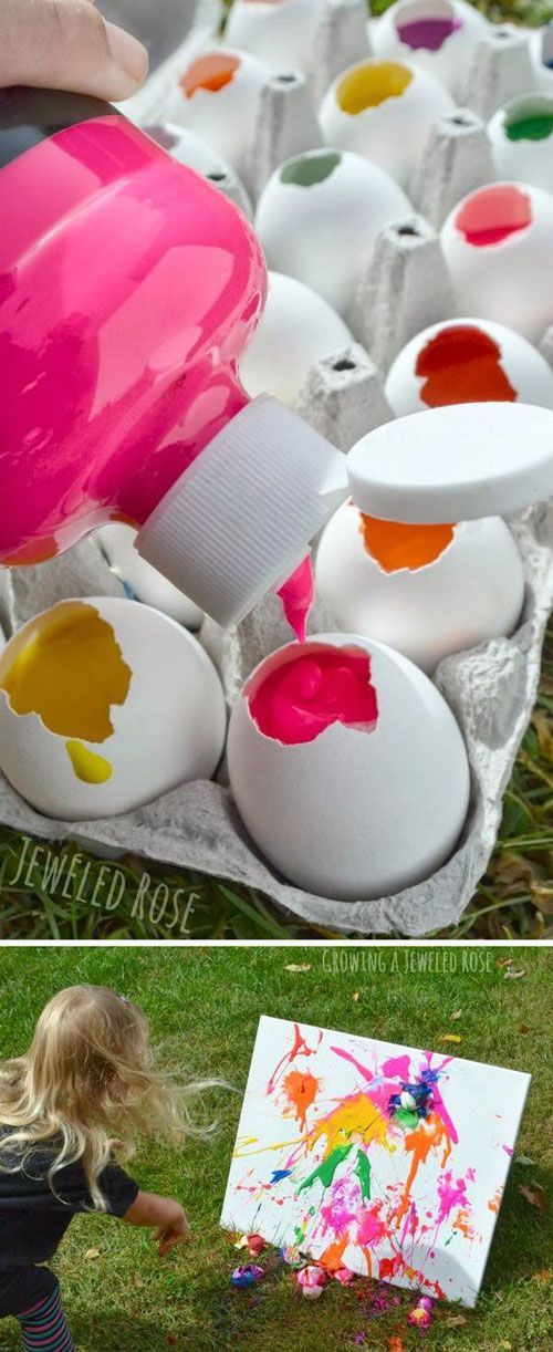 an egg carton filled with painted eggs sitting on top of a grass covered field