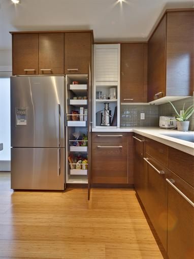 a kitchen with wooden cabinets and stainless steel appliances