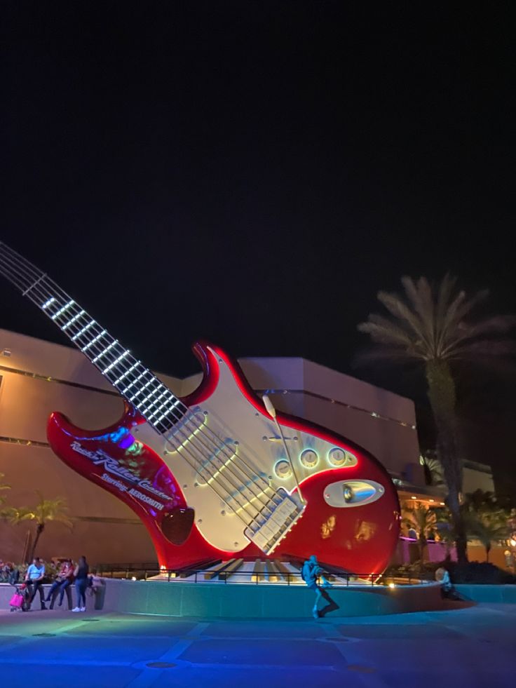 a giant guitar sculpture in front of a building