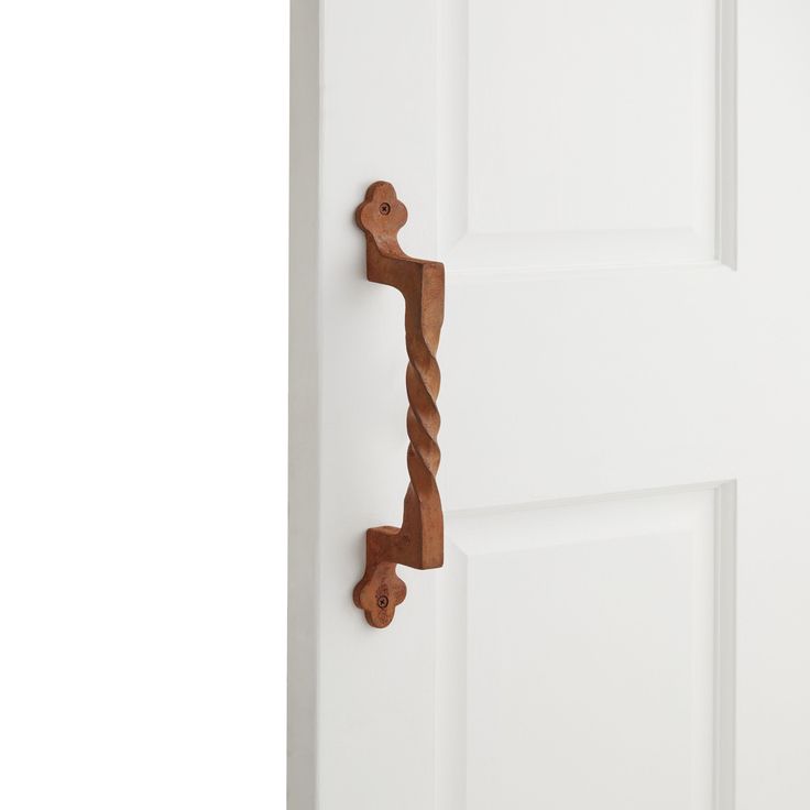 a wooden door handle on the side of a white door