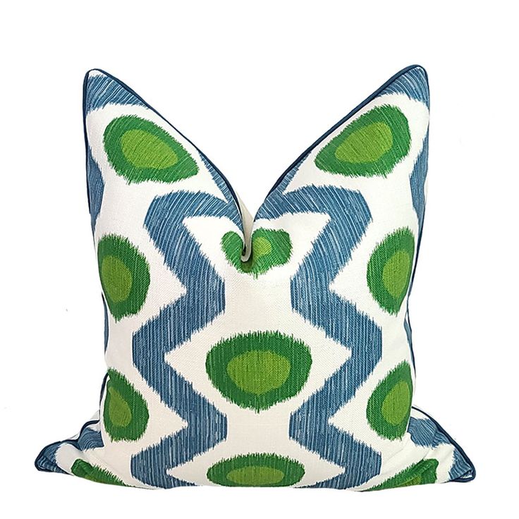 a green and blue pillow on a white background