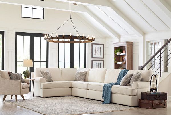 a living room filled with furniture and lots of windows