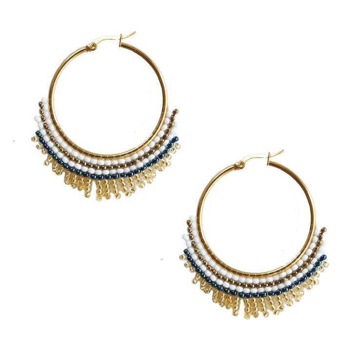 Our best-selling Armada Earring, now available in a large hoop. A classic hoop style with beautiful white, navy, a gold beading that will add a touch of fabulous to any ensemble. Stainless steel hardware for comfort and longevity. Details: Handcrafted by artisans in Medellin, ColombiaMaterials: seed beads / stainless steel hardwareSize: Approximately 1.75 inches in diameterSKU: #E1108 FOSTERIE | Accessories with IntentionFounded on the belief that fashion + compassion can make a positive impact Colombian Culture, Seed Bead Earrings, Bead Earrings, Small Batch, Gold Beads, Seed Bead, Beaded Earrings, Hand Woven, Bead Work