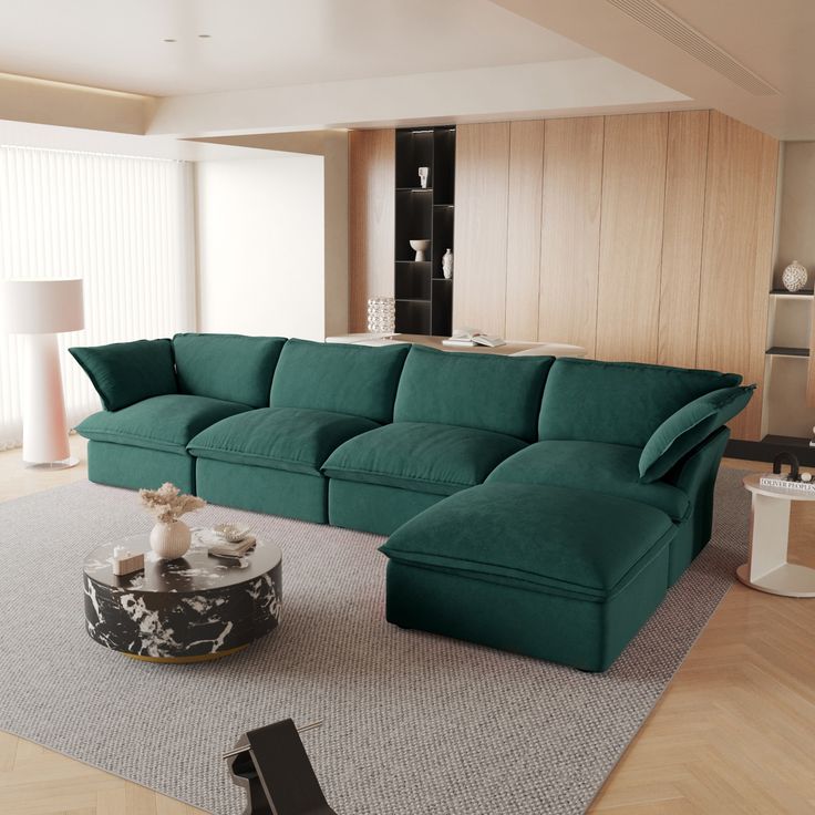 a living room with a large green couch