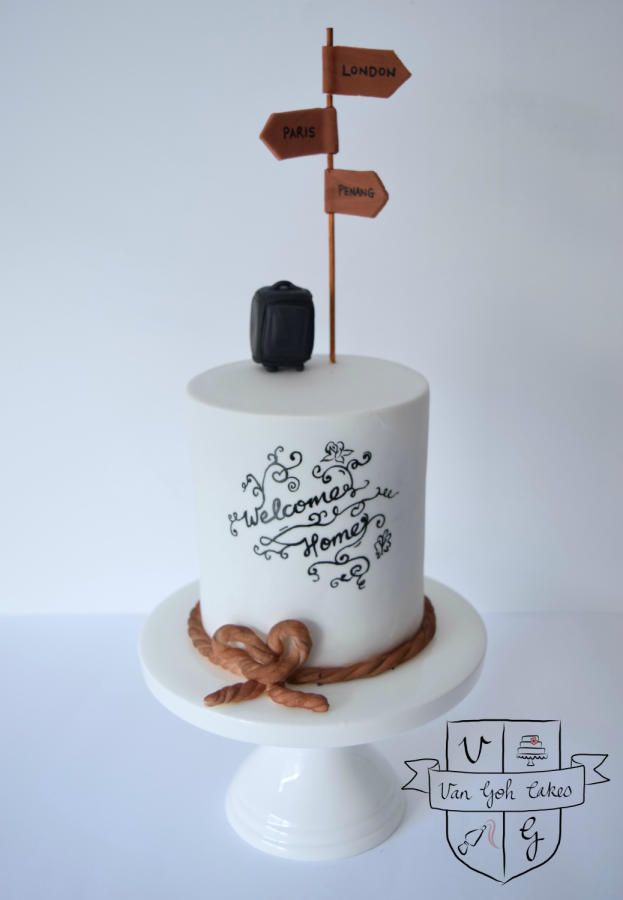 a white cake with brown decorations and wooden signs