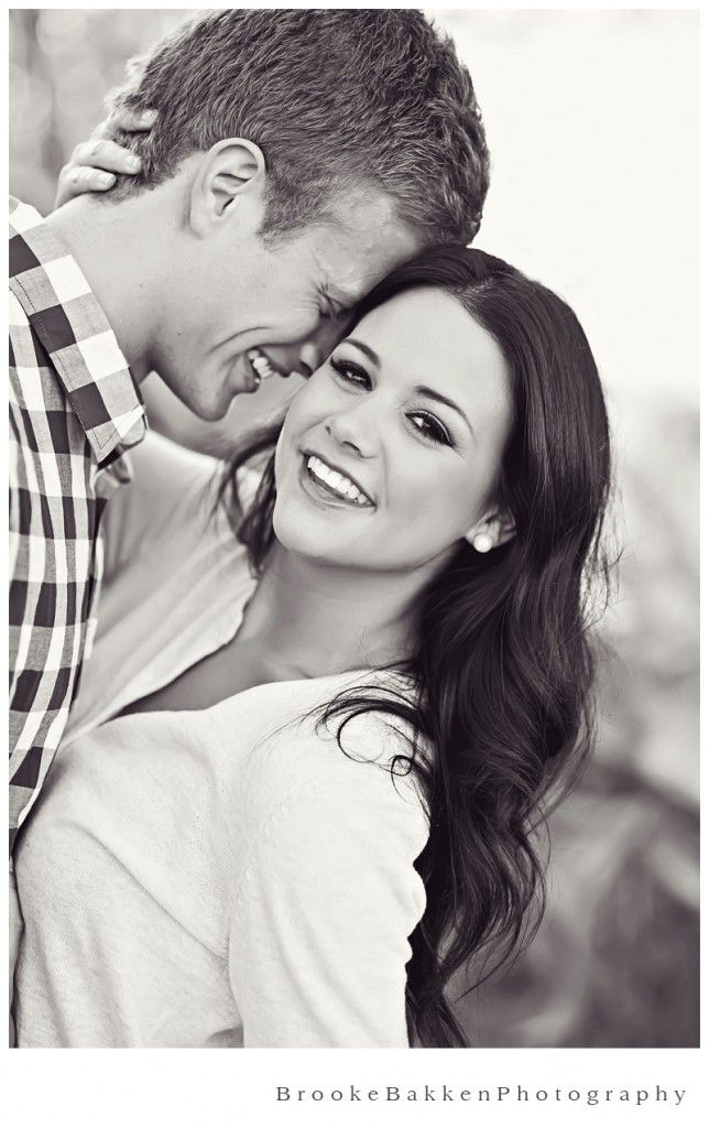 a man and woman hugging each other in front of an instagram page on their phone