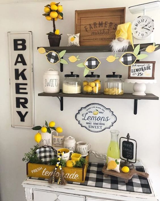 a table topped with lemons and cakes on top of wooden shelves next to a wall