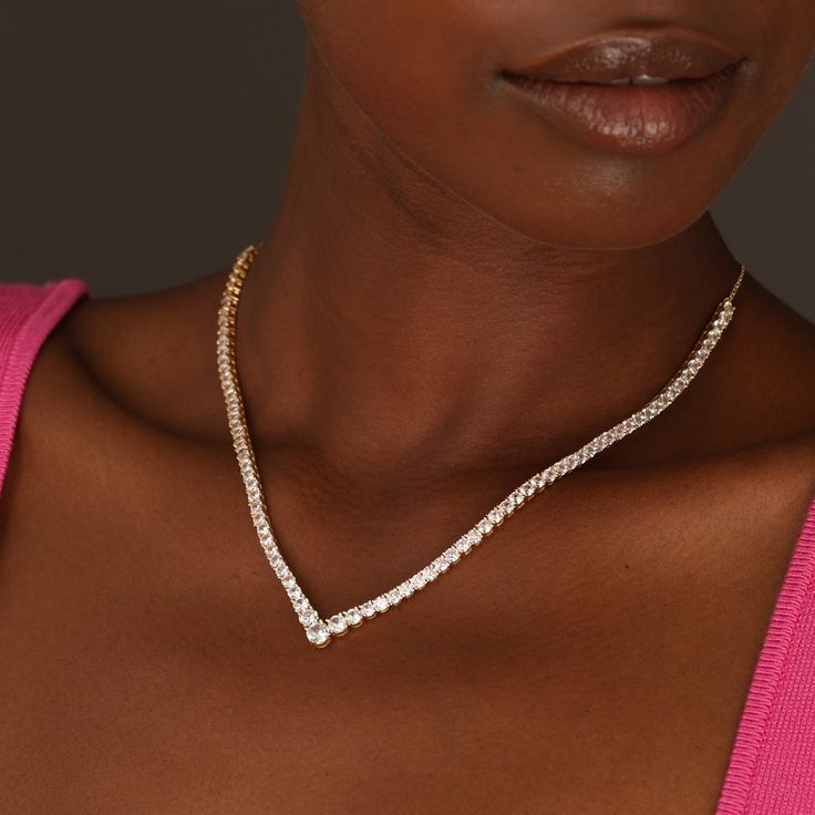 Elevate your style with our exquisite V Tennis Necklace, meticulously crafted in 18k gold vermeil. This timeless piece seamlessly combines classic sophistication with a modern edge, making it a versatile addition to any jewelry collection. Shimmering crystals are carefully placed along the entire length of the necklace, creating a captivating display of brilliance. Get ready to shine with elegance and sophistication wherever you go. Elegant Gold Crystal Necklace, Elegant Formal Tennis Necklace, Gold Crystal Round Cut Necklace, Gold Crystal Necklace With Round Cut, Elegant Crystal Tennis Necklace With Diamond Accents, Elegant Diamond White Tennis Necklace For Everyday Luxury, Classic Rose Gold Tennis Necklace For Formal Occasions, Elegant Gold Plated Diamond Necklace, Gold Diamond Necklace With Vs Clarity For Wedding