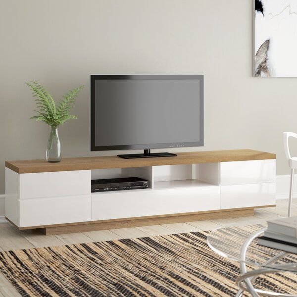 a flat screen tv sitting on top of a white entertainment center