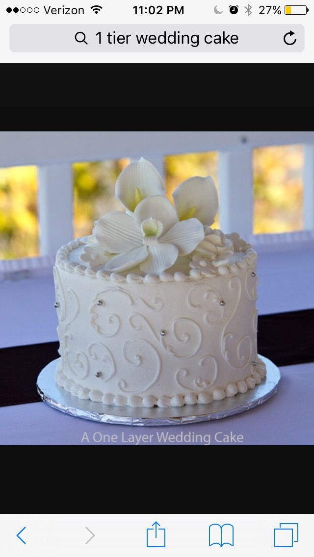 a white wedding cake with flowers on top