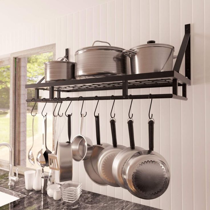 an image of a kitchen with pots and pans on the rack