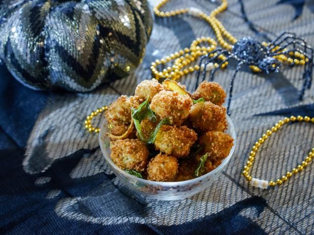 a bowl filled with fried food on top of a blue table cloth next to beads