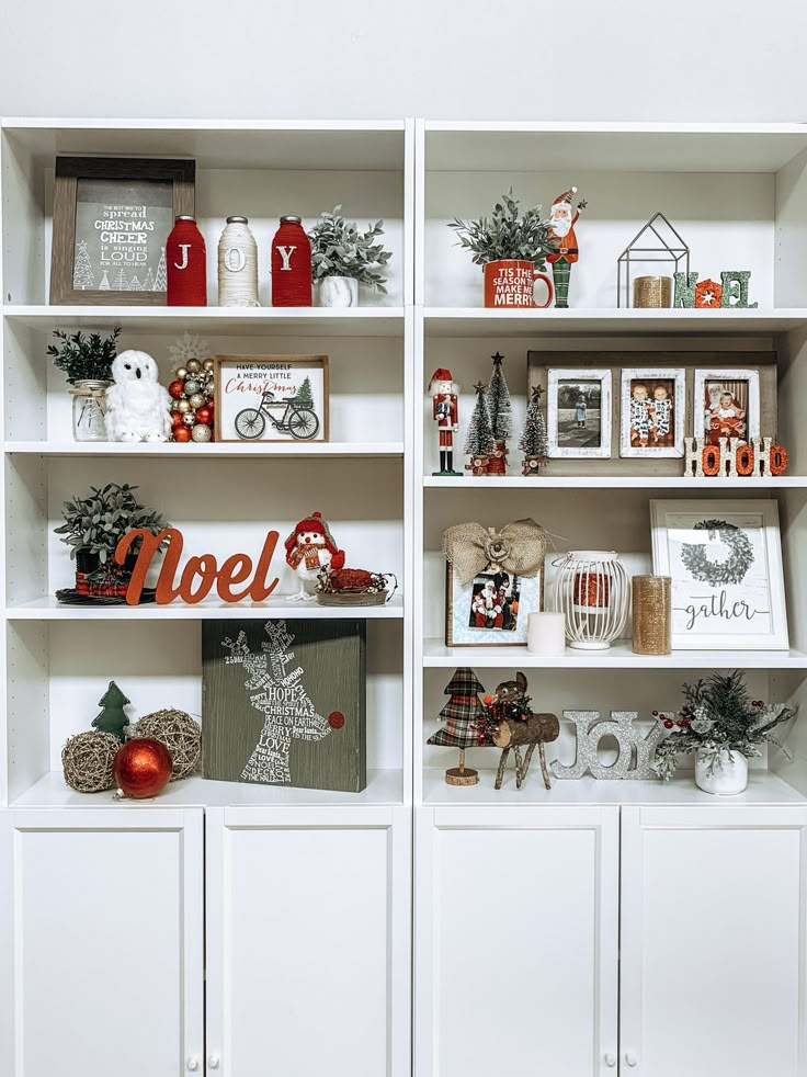 a white book shelf filled with lots of christmas decorations