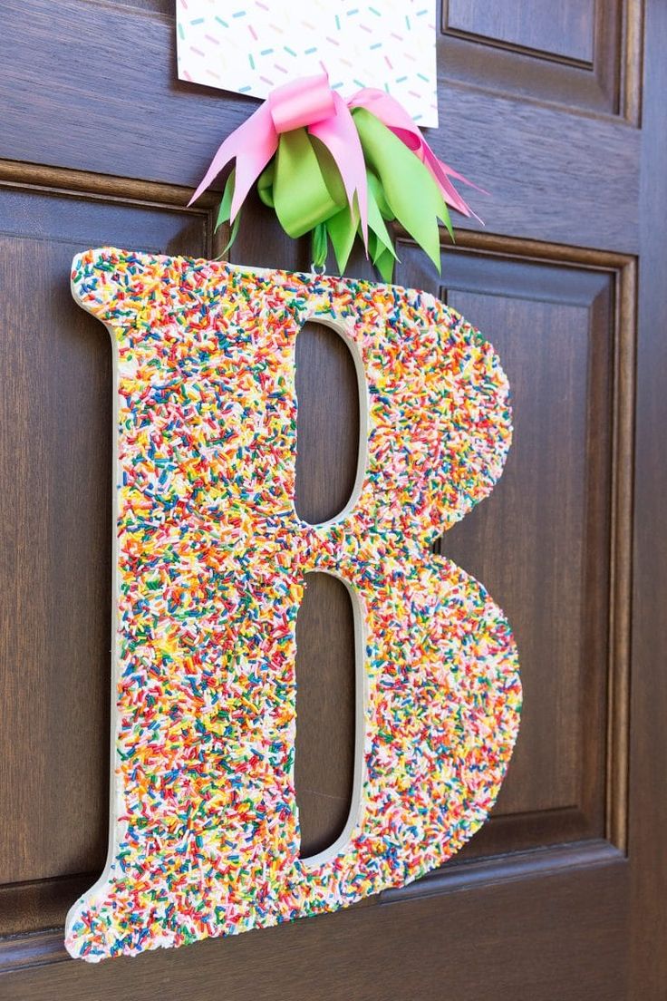 the letter b is made out of sprinkles and sits on a door