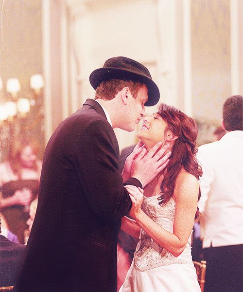 a bride and groom kissing each other in the middle of their wedding reception at a banquet hall