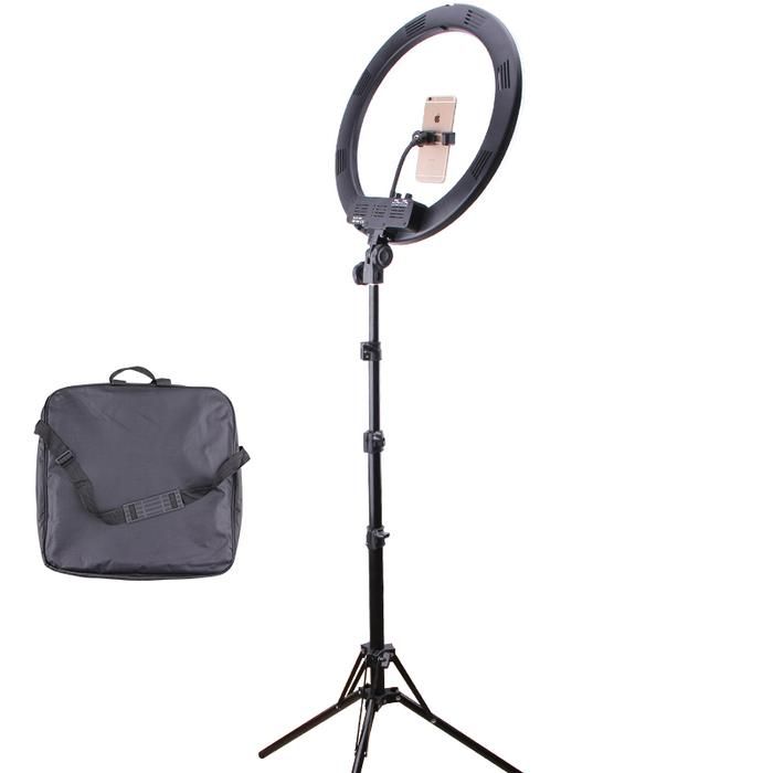 a tripod light with a bag on it and a phone in the back ground