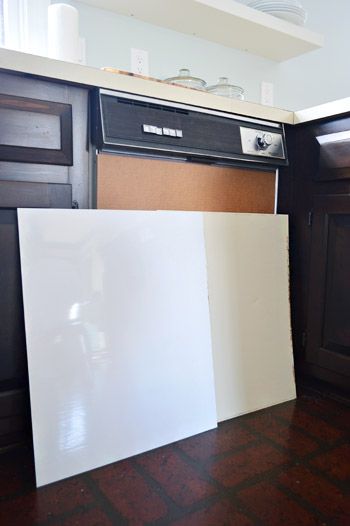 a kitchen with black cabinets and white counter tops