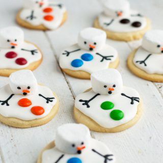 decorated cookies with frosting and icing are arranged in the shape of snowmen