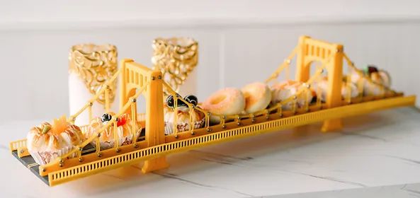 a miniature model of a bridge with food on it