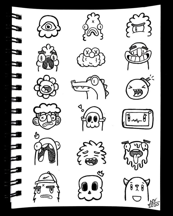 an open notebook with doodled stickers on the pages, including monsters and other cartoon characters