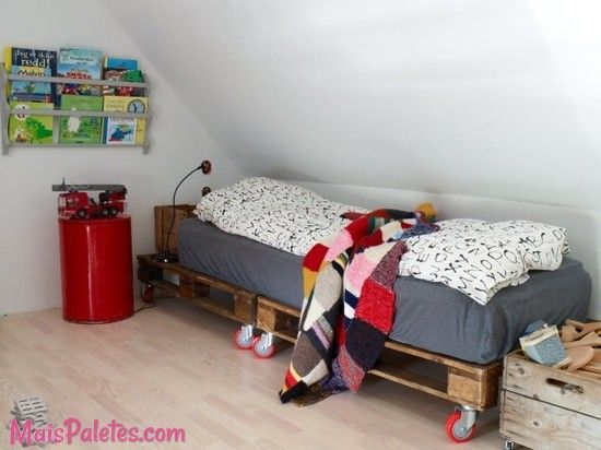 a bed sitting in the middle of a bedroom next to a red fire hydrant