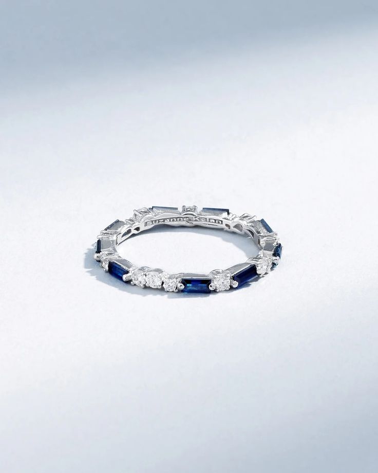 a white gold ring with blue sapphires and diamonds