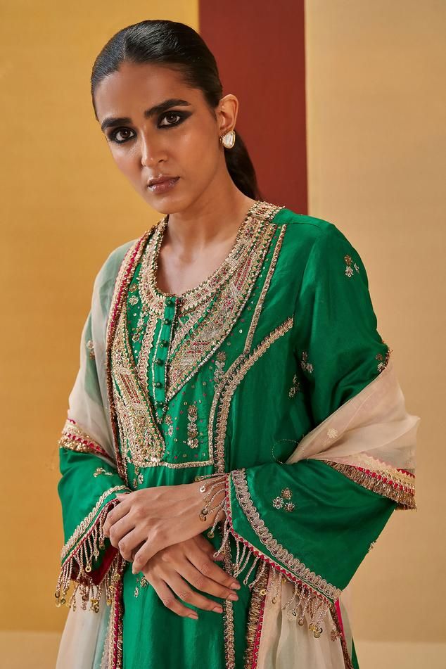 Green A-line kurta with zardozi, sequin, gota embroidered yoke in geometric pattern. Paired with pant and ivory dupatta.
Components: 3
Pattern: Embroidery
Type Of Work: Zardozi, sequin, gota, geometric
Neckline: Round
Sleeve Type: Bell sleeves
Fabric: Silk Organza
Color: Green
Other Details: 
Contrast sheer dupatta
Front embellished buttons
Tassel fringe border
Embroidery on pan hem
Occasion: Sangeet - Aza Fashions Ivory Dupatta, Priyanka Singh, Embroidery Zardozi, Sheer Dupatta, Embellished Buttons, Organza Embroidery, Kurta Set For Women, A Line Kurta, Border Embroidery