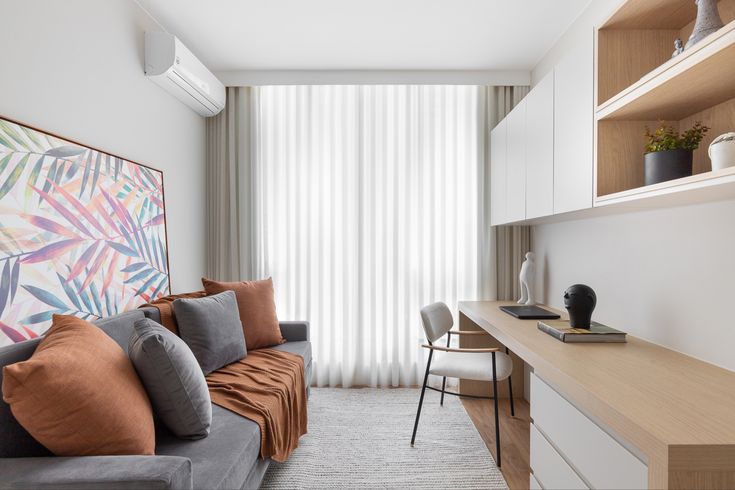 a living room filled with furniture and a painting on the wall