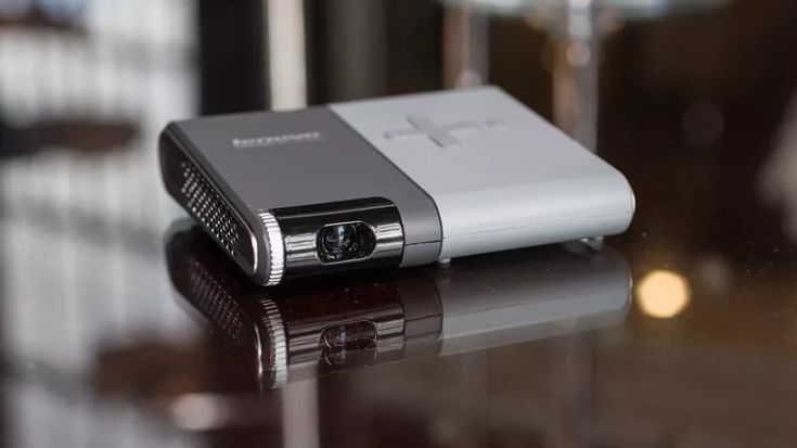 a silver and black cell phone sitting on top of a table