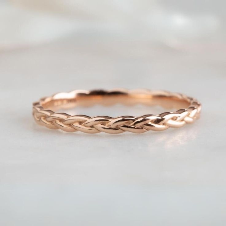 a gold braided ring sitting on top of a table