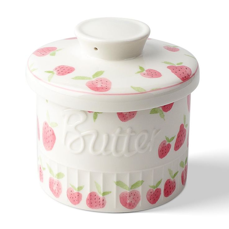 a white and pink ceramic container with strawberries on it