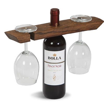 a wine glass holder with two wine glasses hanging from it's side and a bottle in the middle