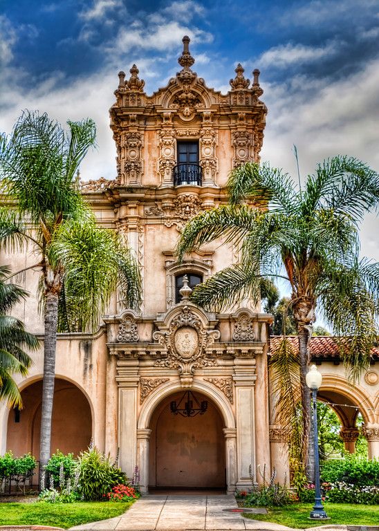 an old building with palm trees in front of it