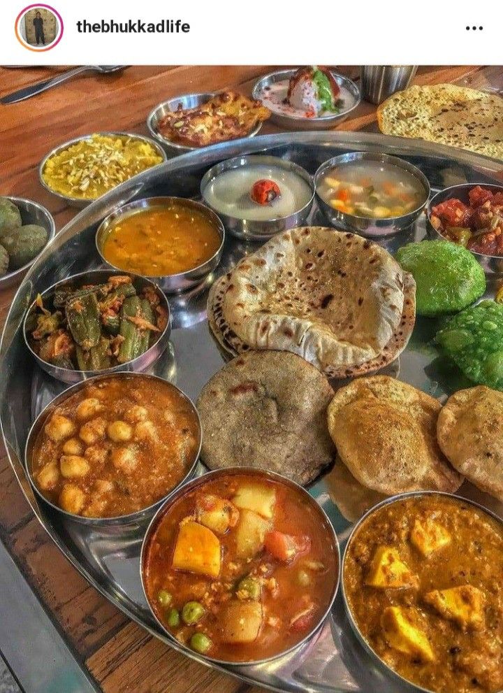 many different types of food on a metal platter