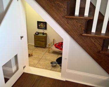 an open door leading to a room with stairs and a dog bowl on the floor