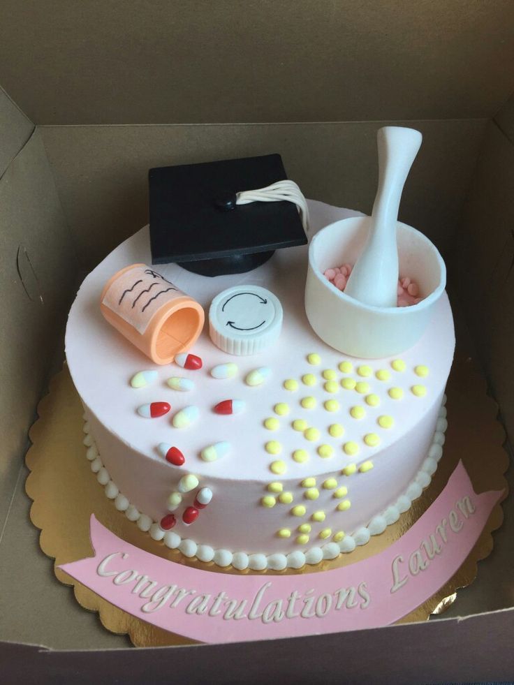 a graduation cake in the shape of a box with confetti and mortars