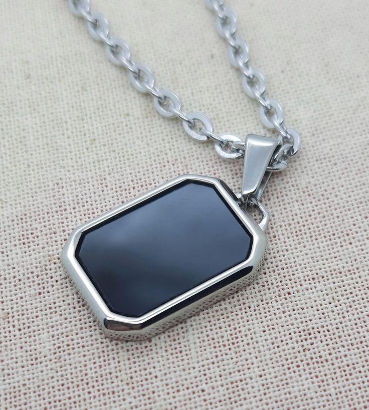 Rectangle imitation onyx pendant necklace. Stylish, minimalist jewellery for men. Simple and discreet, suitable for casual or formal wear. Great gift for men, birthdays, christmas, anniversaries. Pendant 21mm x 15mm. With 3mm flat cable chain or 2mm box chain. Available in various lengths to suit all tastes. Premium  stainless steel -  * Durable * Waterproof * Hypoallergenic * Tarnish and scratch resistant * High strength * Lasting colour * Shiny  * Comfortable to wear * Affordable  We keep pack Black Minimalist Rectangular Pendant Jewelry, Formal Black Rectangular Necklace, Rectangular Stainless Steel Necklaces, Modern Black Necklace With Square Pendant, Modern Black Jewelry With Rectangular Stone, Minimalist Black Rectangular Jewelry, Modern Black Square Pendant Jewelry, Modern Black Square Pendant Necklace, Rectangular Black Necklaces For Gifts