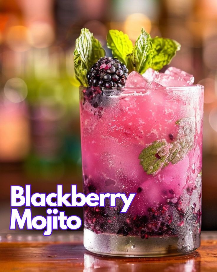 a blackberry mojito with ice and mint garnish