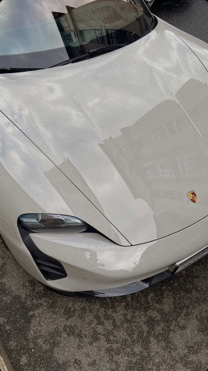 a white sports car is parked on the street