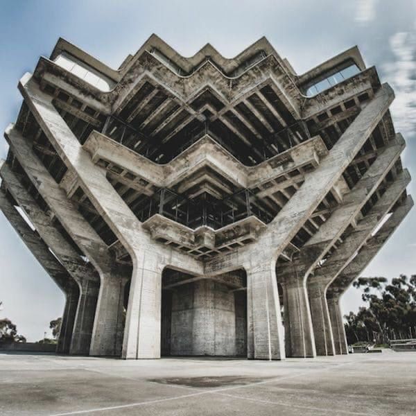 an unusual building with multiple floors and windows